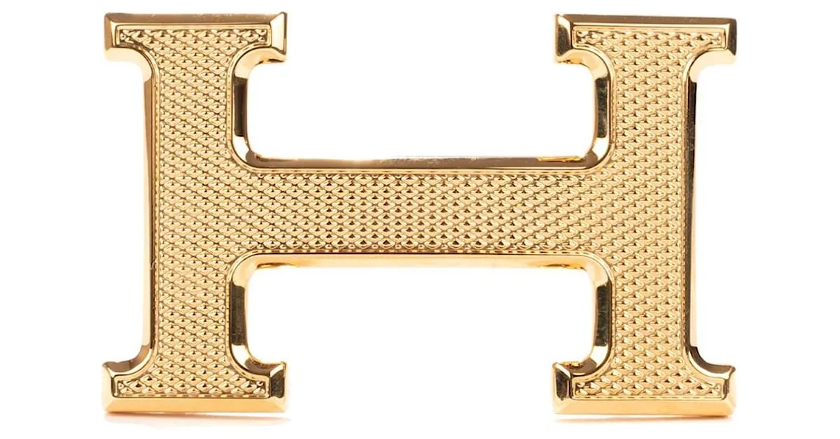 Magnífica hebilla Hermès Constance Guilloche en metal dorado 