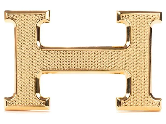 Magnífica hebilla Hermès Constance Guilloche en metal dorado 