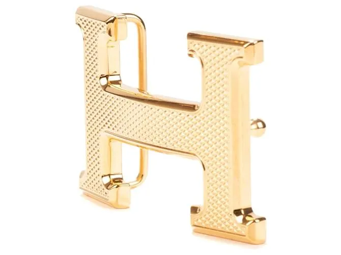 Magnífica hebilla Hermès Constance Guilloche en metal dorado 