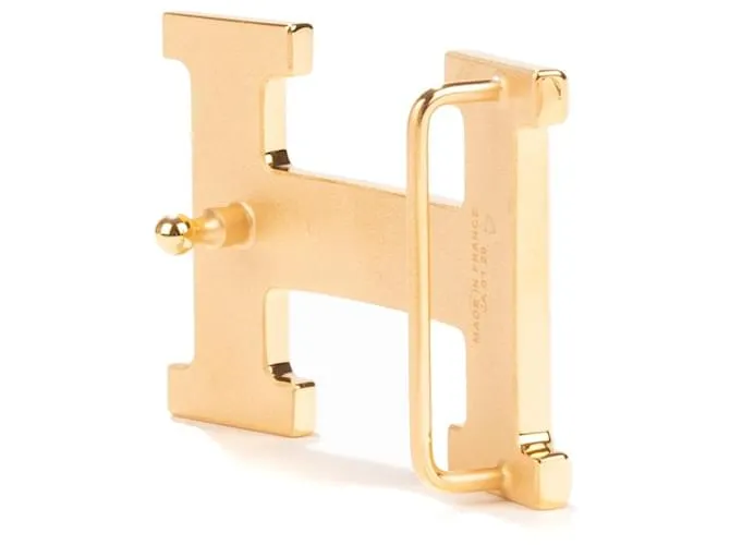 Magnífica hebilla Hermès Constance Guilloche en metal dorado 
