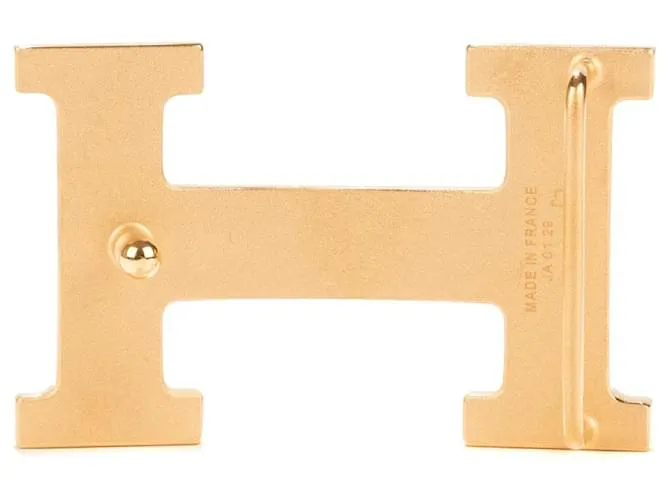 Magnífica hebilla Hermès Constance Guilloche en metal dorado 